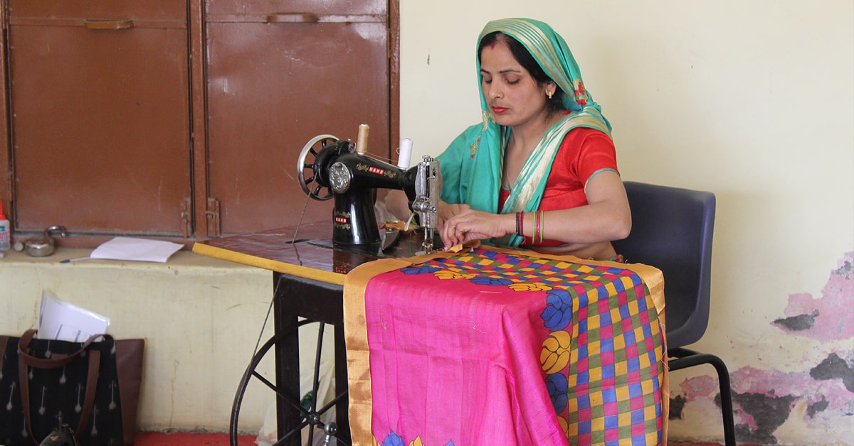 Bandhwari woman at sewing machine